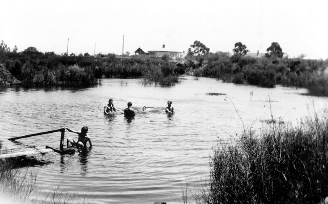 Moulding apprentices enjoying a dip in Quarry pool at Steel Company of Australia Mill