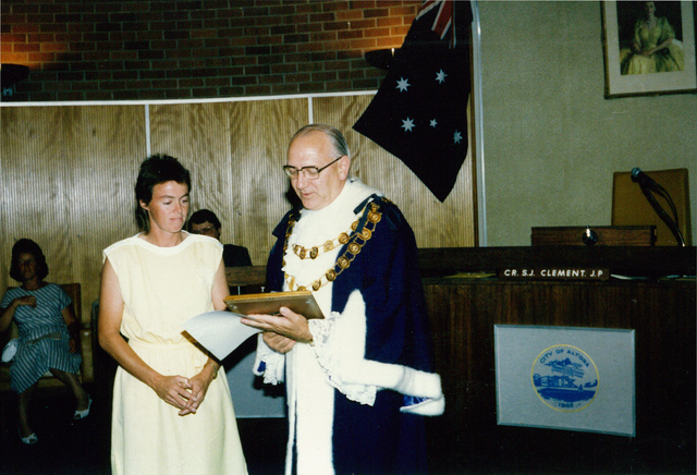 Councillor S.J. Clement presenting an award to woman in Council Chambers