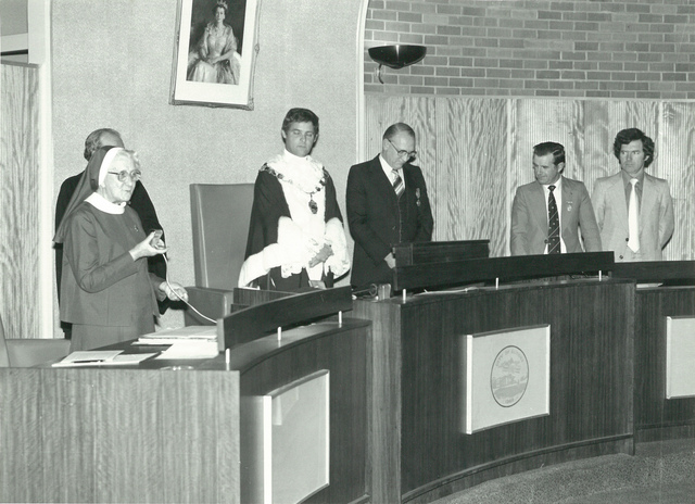 Mayor D.N. Duane listening to nun