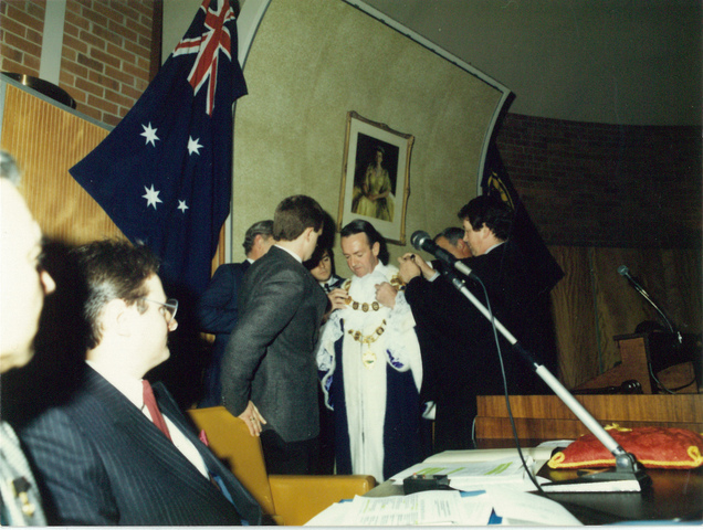 City of Altona Councillor W.H. Sommers being dressed in Mayoral robes