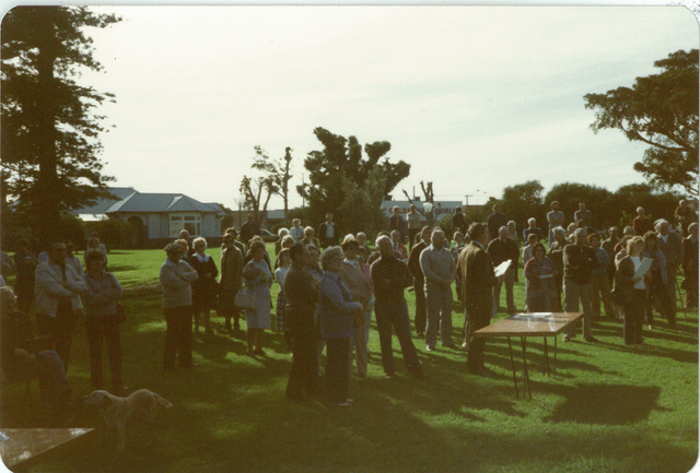 A crowd of people and a table