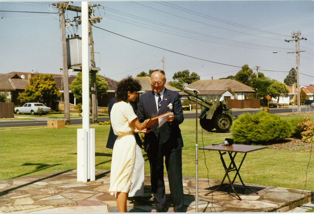 Mayor W.L.J. Crofts presenting an award to Maryanne Vasallo at 150th celebrations outside the Altona Council Chambers