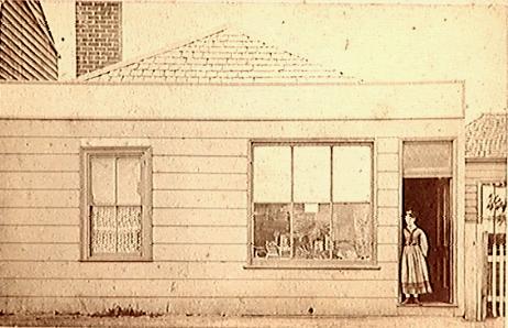 [Woman standing in doorway of shop]