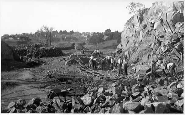 [sustenance workers loading rocks]