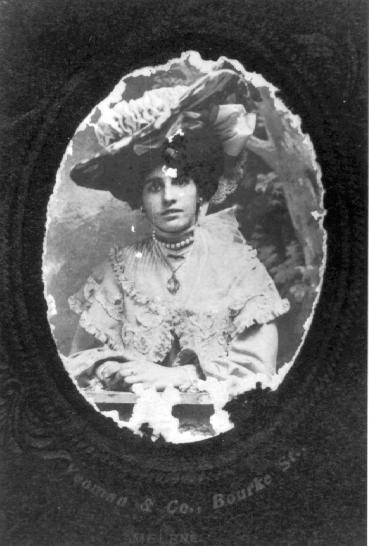 Dark-eyed woman in enormous hat