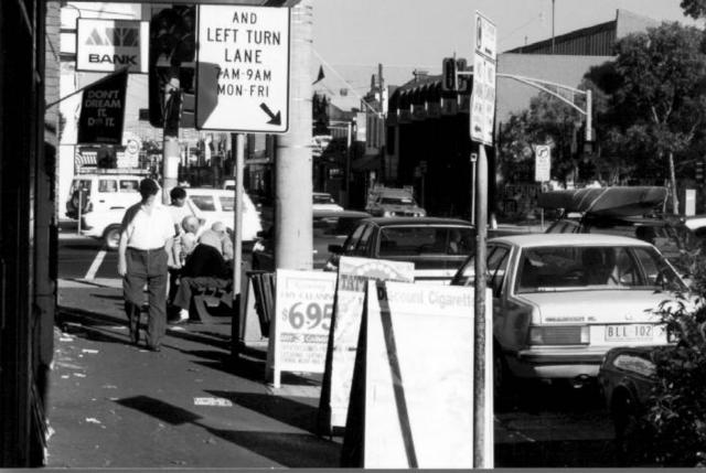 Elderly citizens having a chat while others are hurrying to work