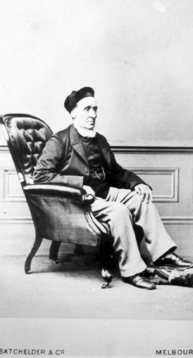 J. P. Fawkner seated in an armchair