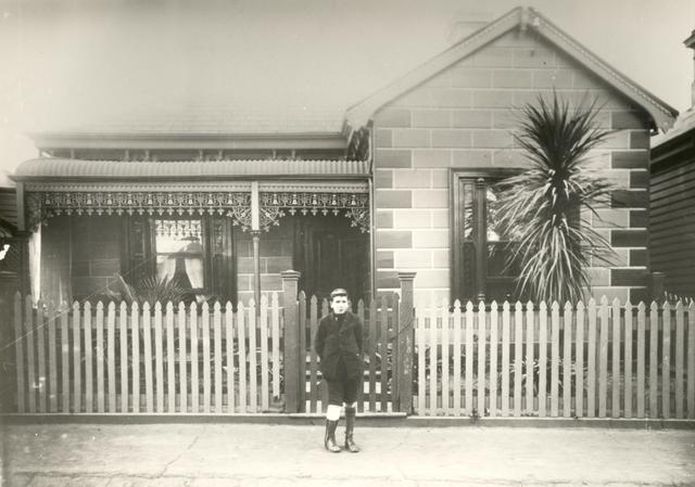 Boy in front of house