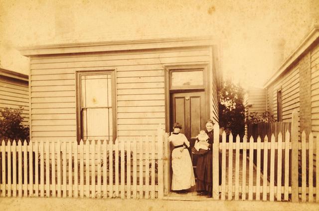 Two women and a baby outside 161 Rupert Street