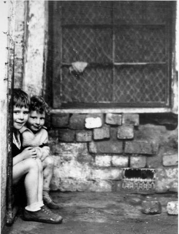 Children outside condemned house.